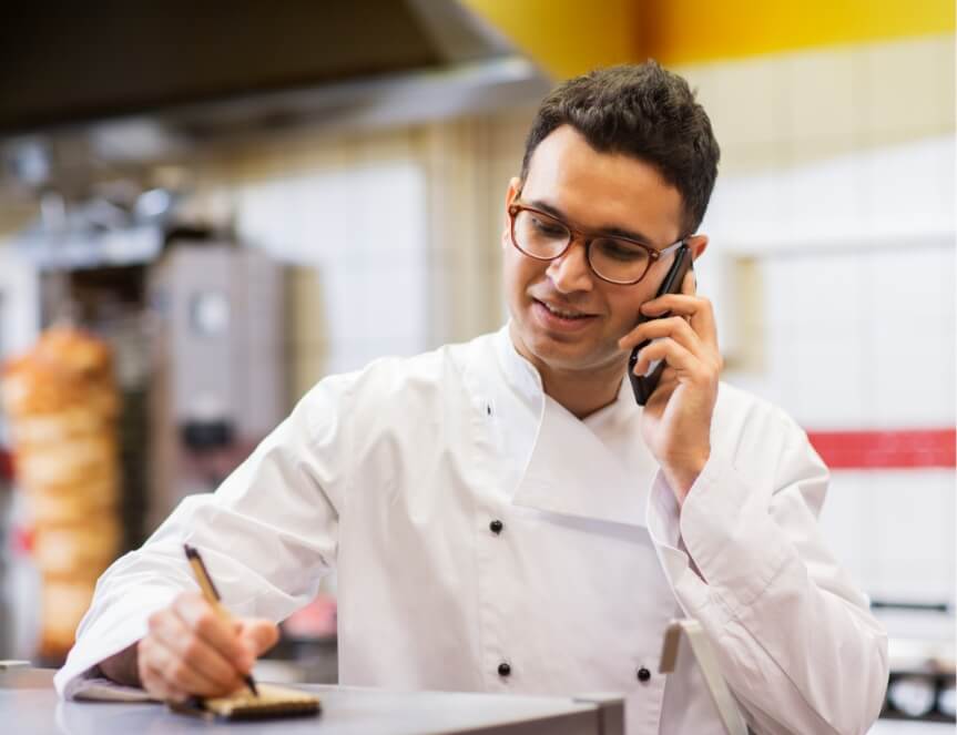 A chef taking a phone call